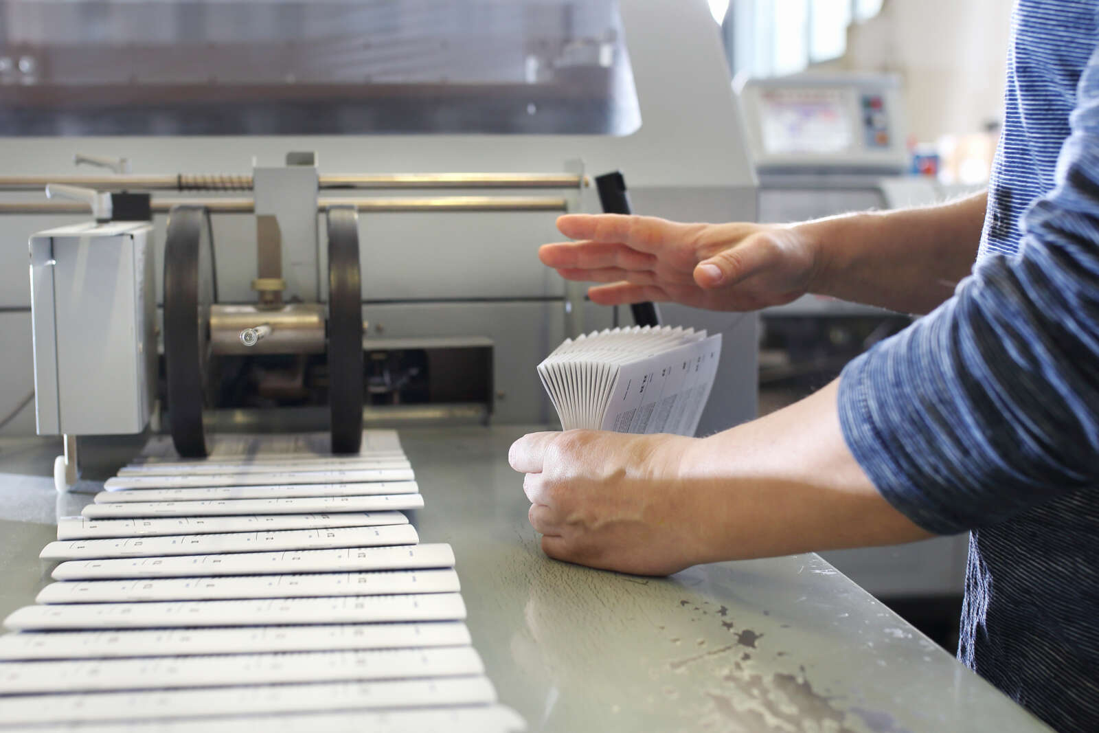 Hands holding folded paper.