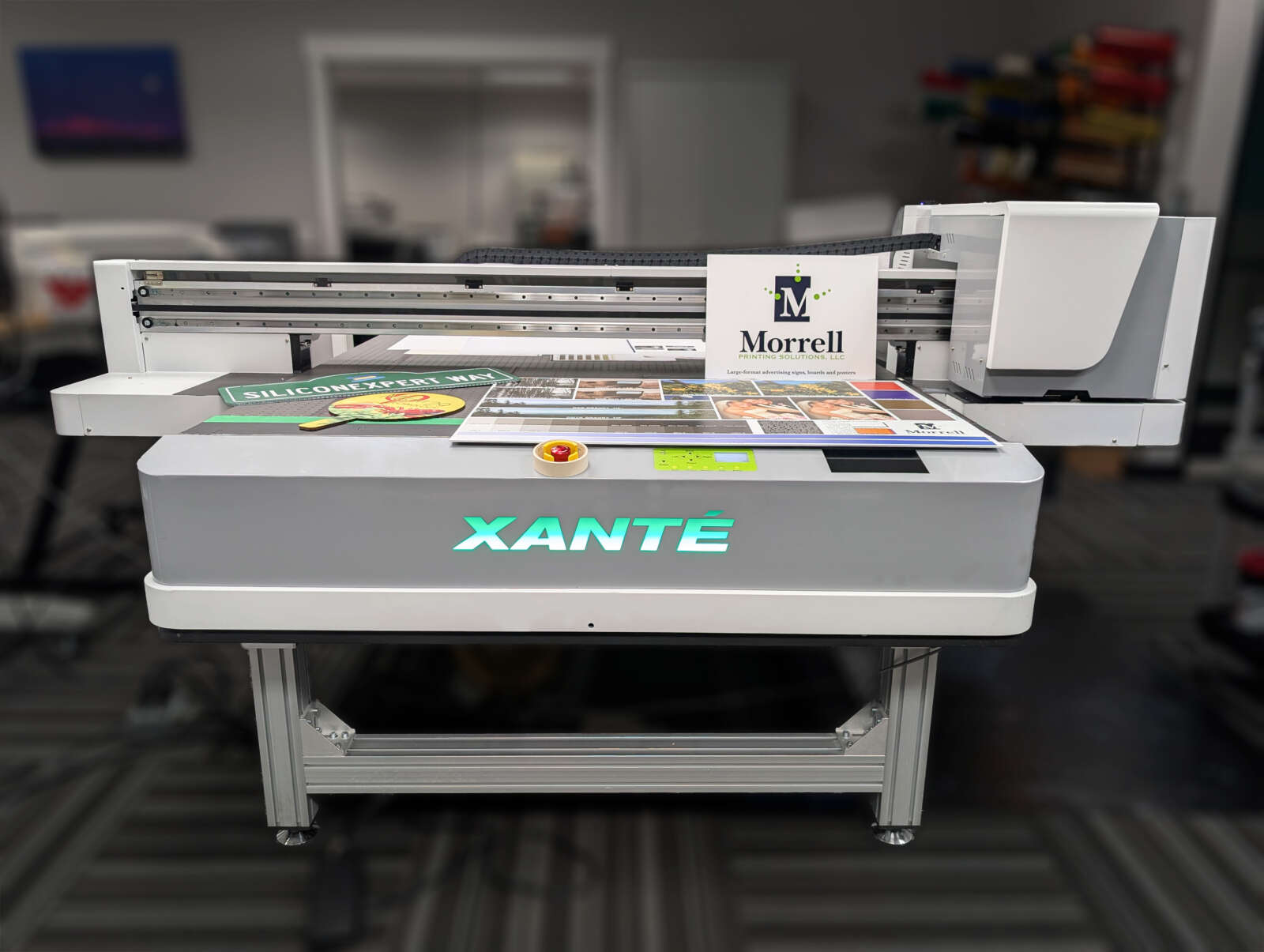 A flatbed uv printer with a variety of products shown